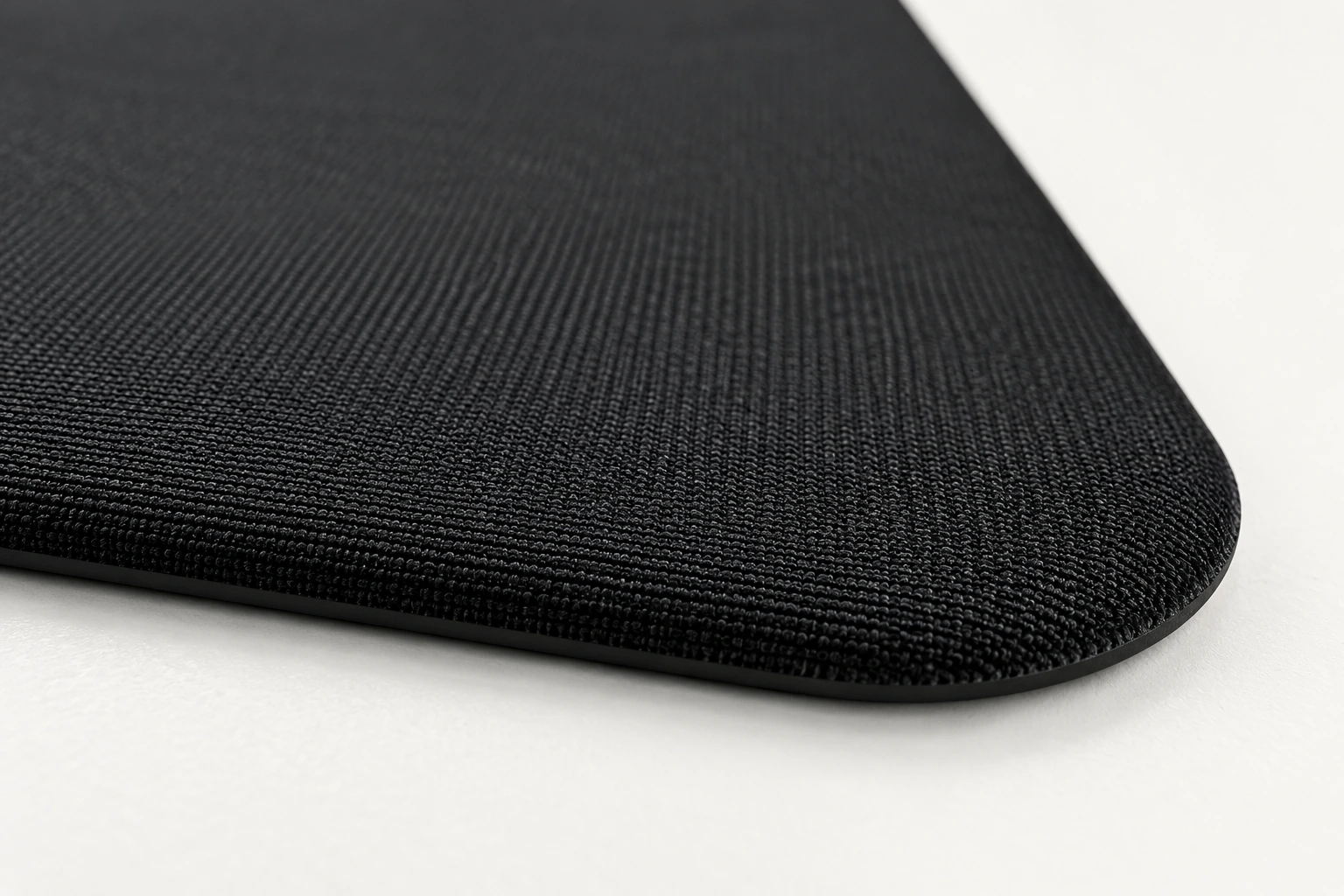 Close-up of the black fabric curving smoothly into the thin base, with no stitching or white seam
